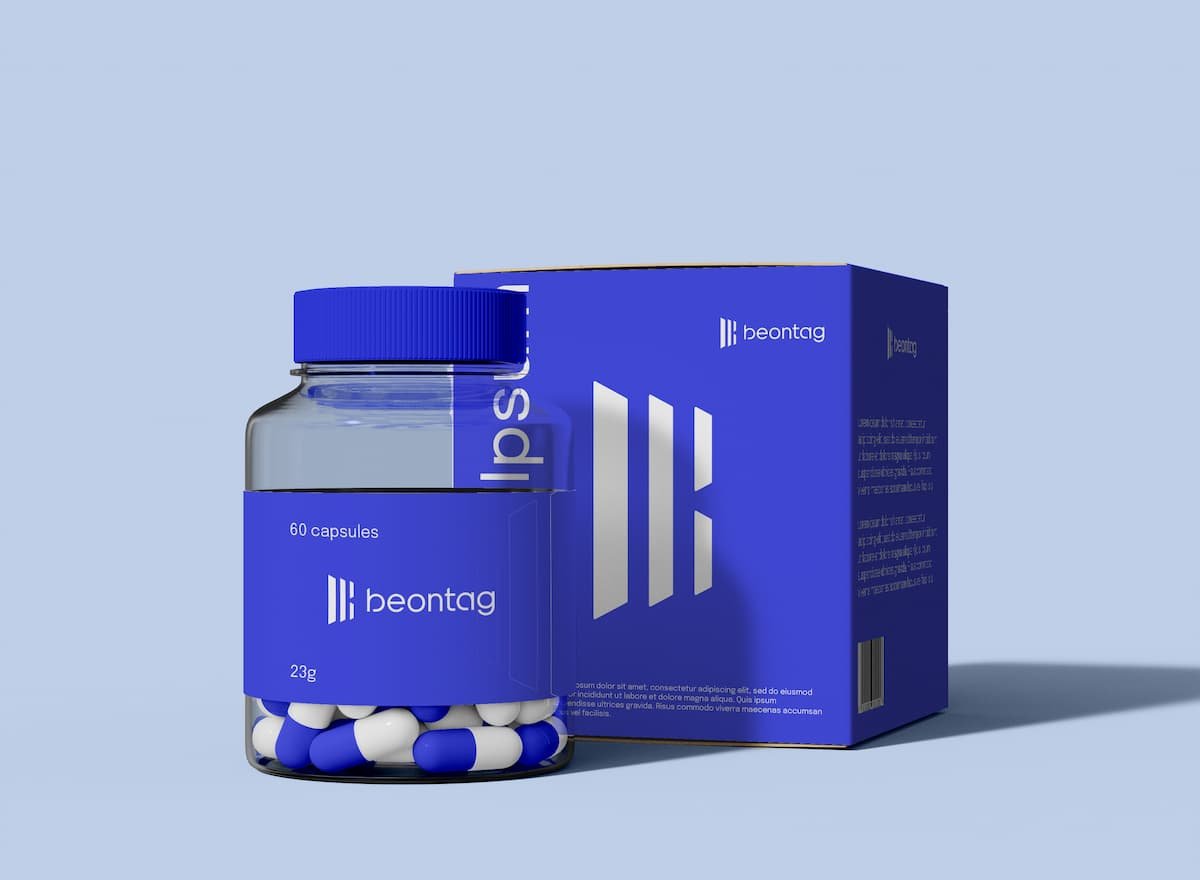 Blue capsule bottle and matching pharmaceutical box with self-adhesive labels, highlighting branded packaging for healthcare and supplement products.